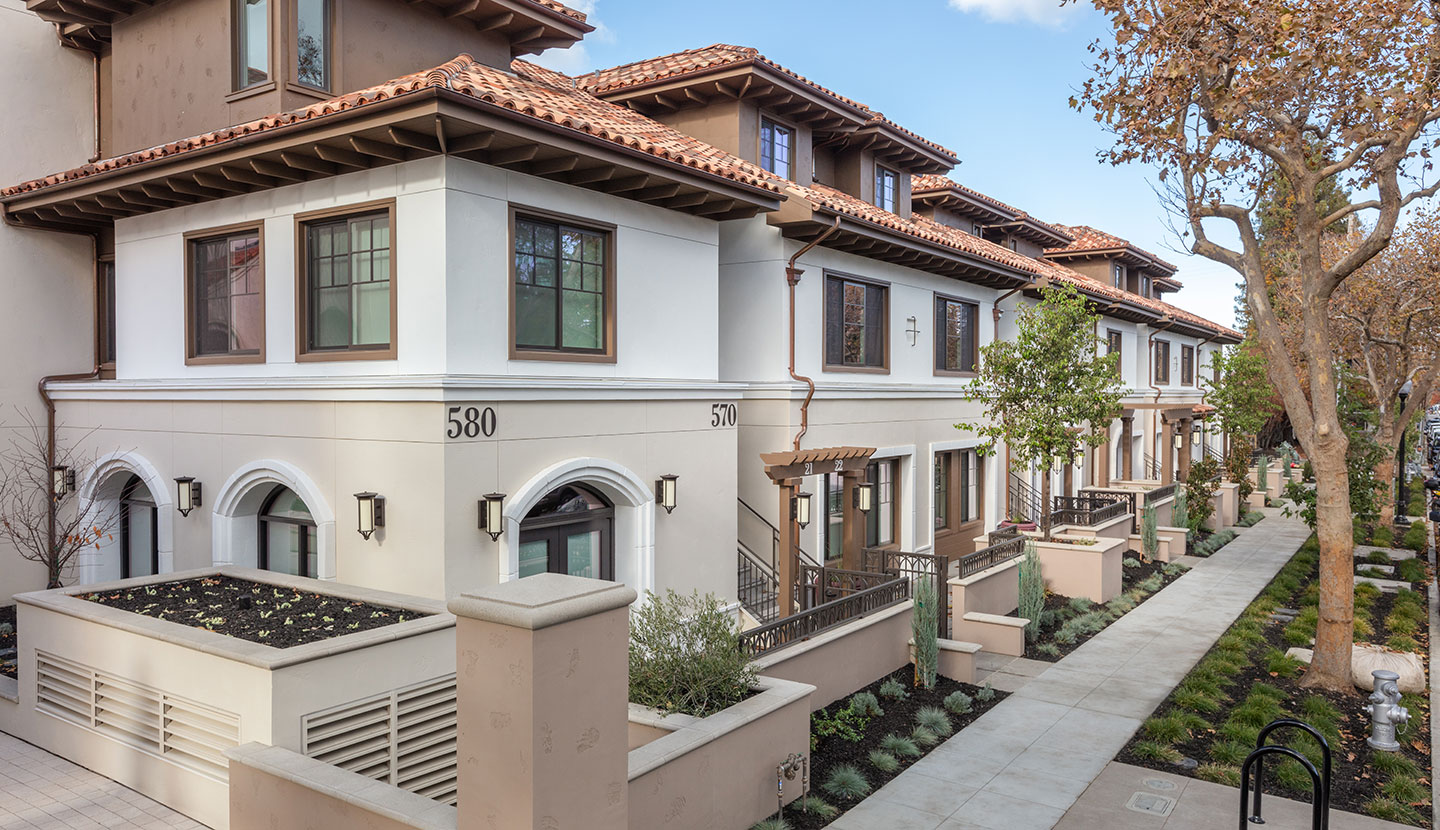 Spanish style exterior of two level apartment building