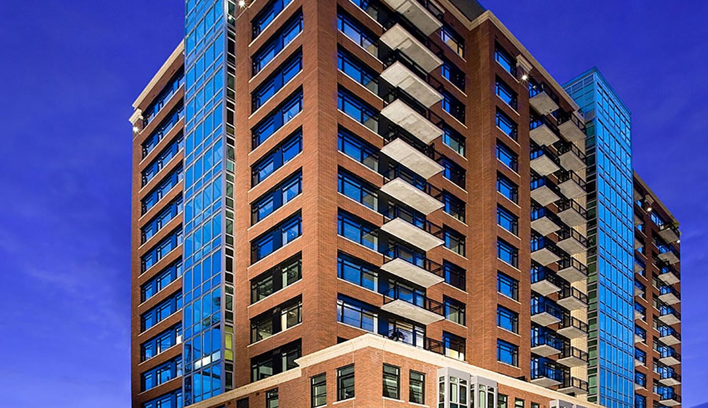 Corner view of tall apartment building at evening