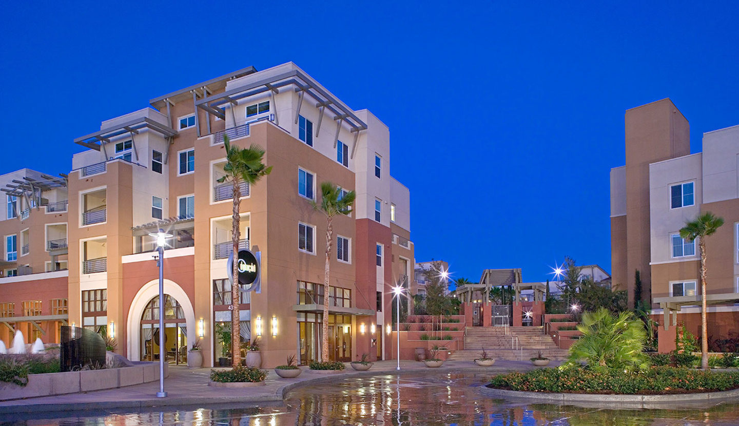 Front view of a multilevel apartment complex with several structures