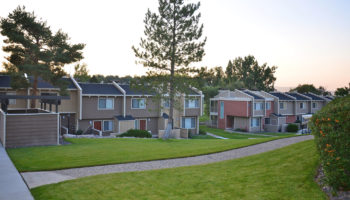 Exterior of a two level apartment community at dusk