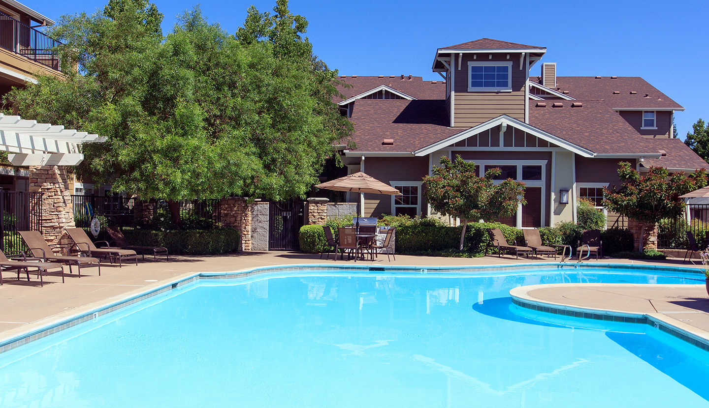 Community pool with the clubhouse in the background