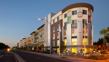 Exterior of a four-story apartment building in the evening