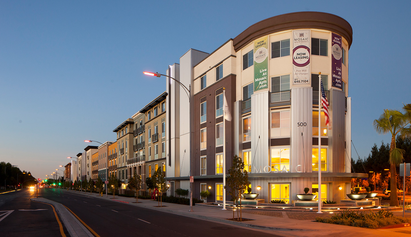 Exterior of a four-story apartment building in the evening