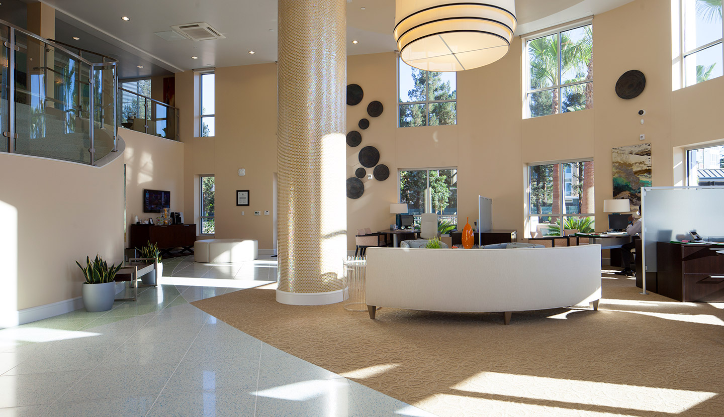 View of the clubhouse of the apartment complex. There are rounded couches.