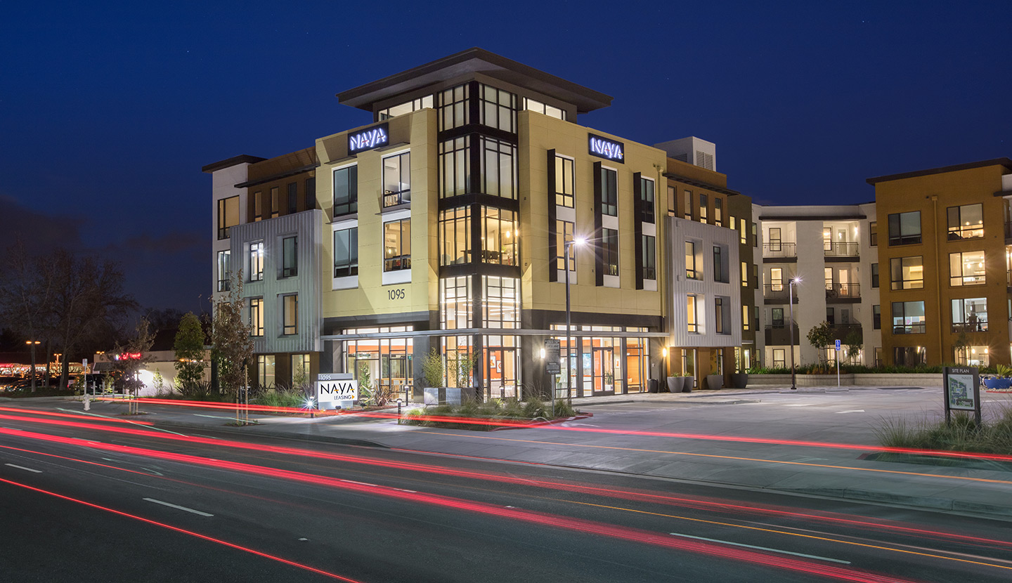 Exterior of three story apartment building in the evening