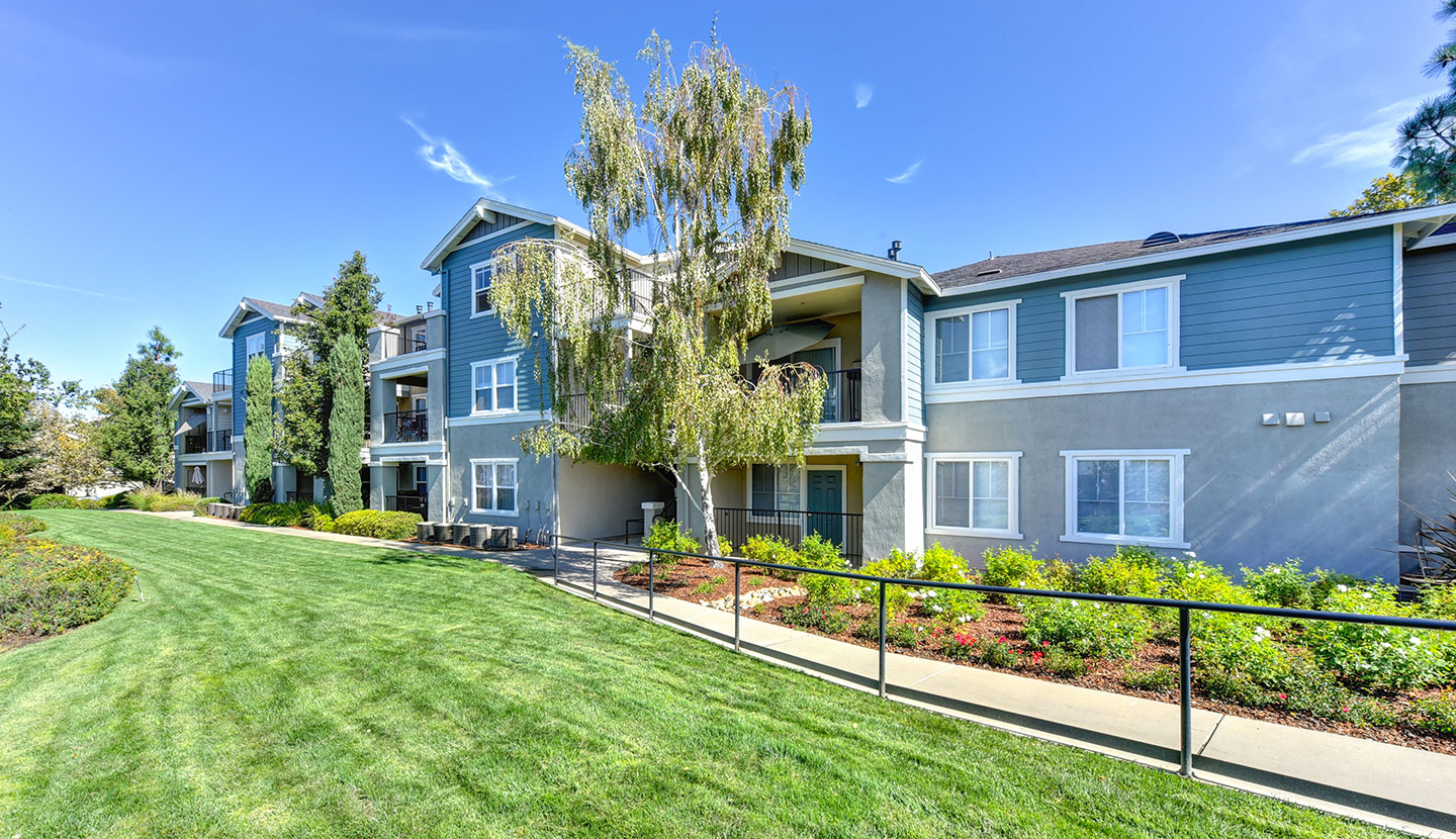 Lawn and landscaping in front of a two-story building