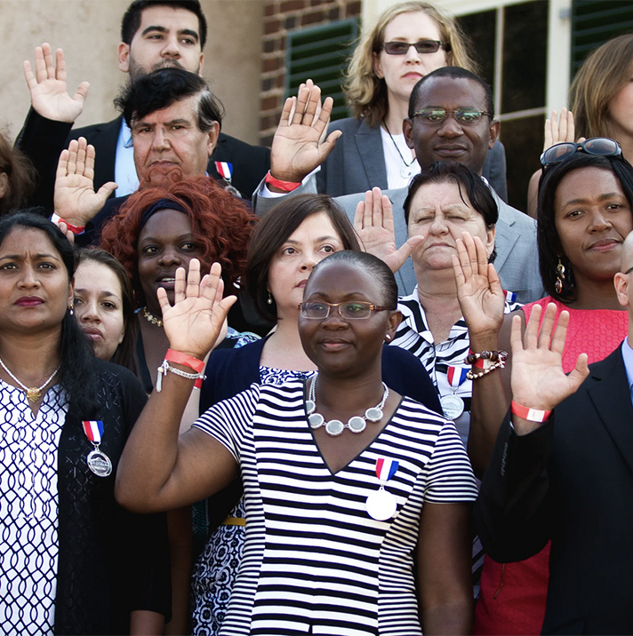 people with right hands raised