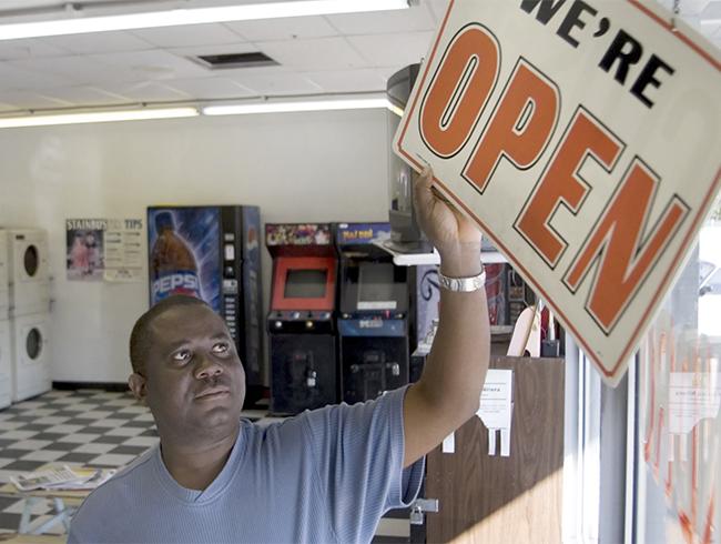 man with open sign