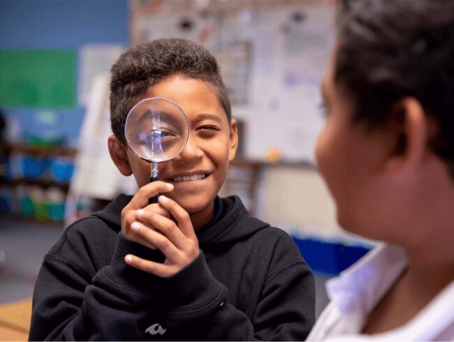 child with a magnifying glass