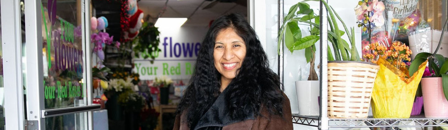 woman in doorway of flower shop